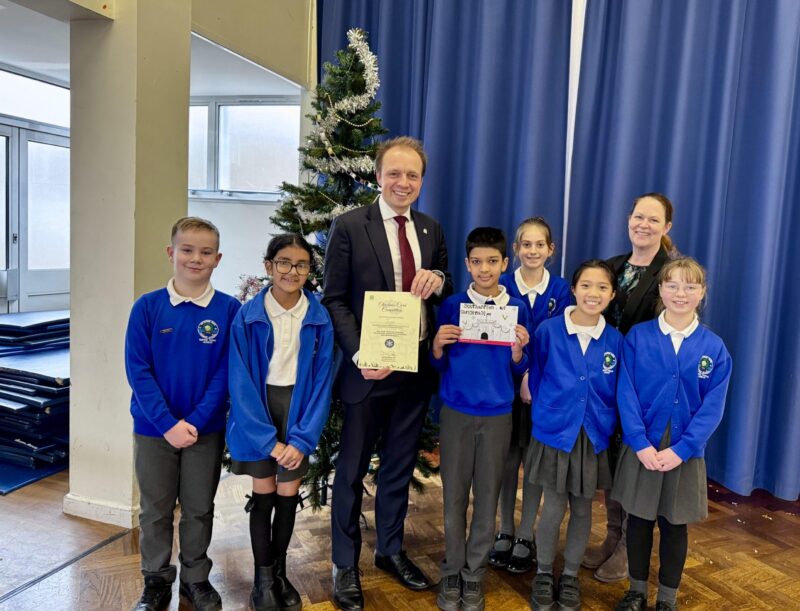 Darren presents a certificate to classmates of Jaya, the winning pupil from Bitterne Park Primary School.