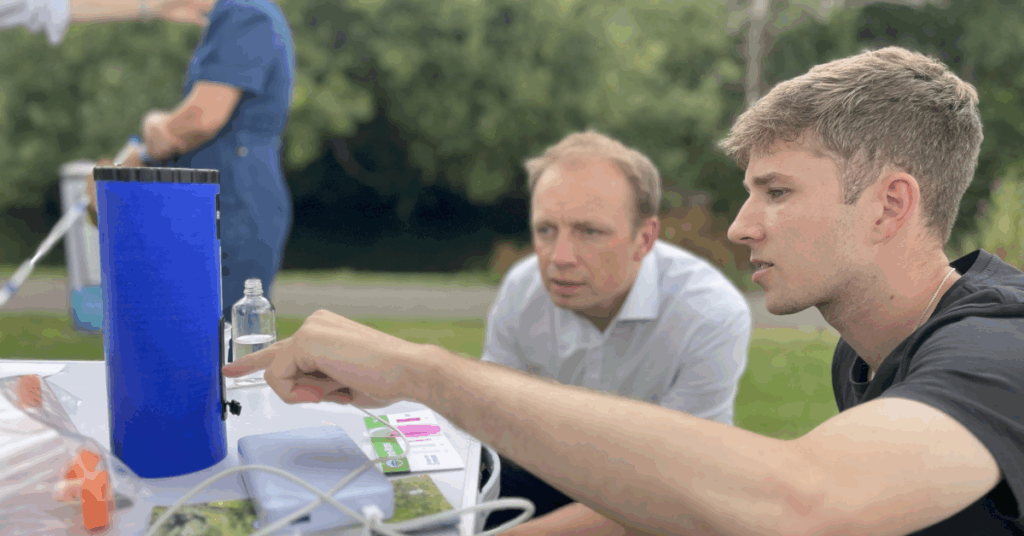 Darren and a representative from River Action UK look at the result of pollution testing in the River Itchen