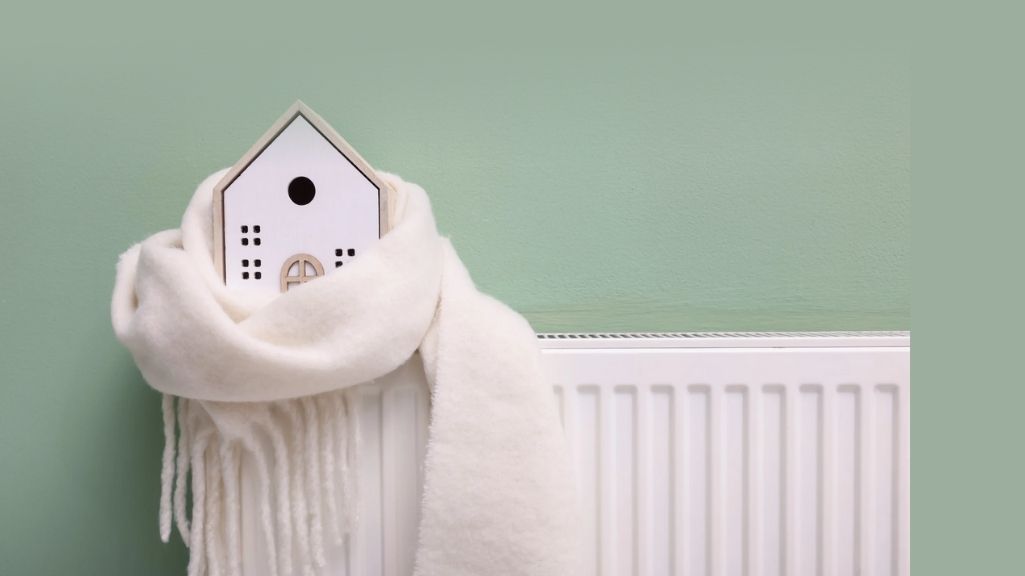 A picture of a radiator against a light green wall
